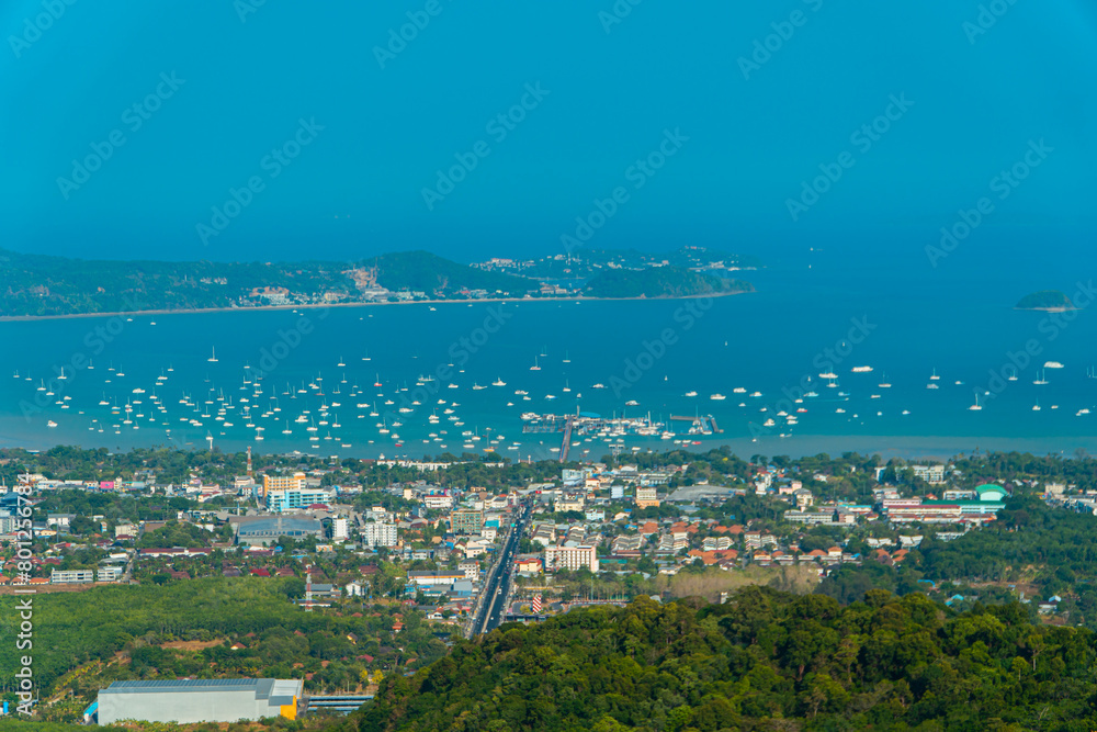 The Big Buddha Phuket viewpoint shows views of the land, the beach, the surrounding boats and the island which is not too far away. Panoramic beauty with a blue sky background during the day