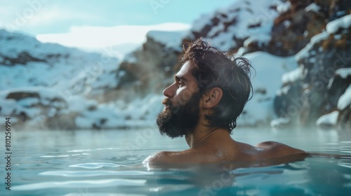 Male relax in hot spring spa with snow mountain in winter.