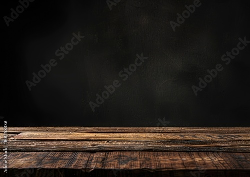 An empty wooden table in a dark room with smoke rising from it