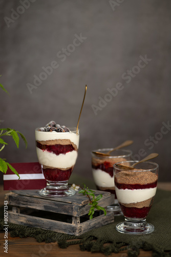 Selective focus rye bread traditional Latvian desert with cream and cranberries front view vertical
