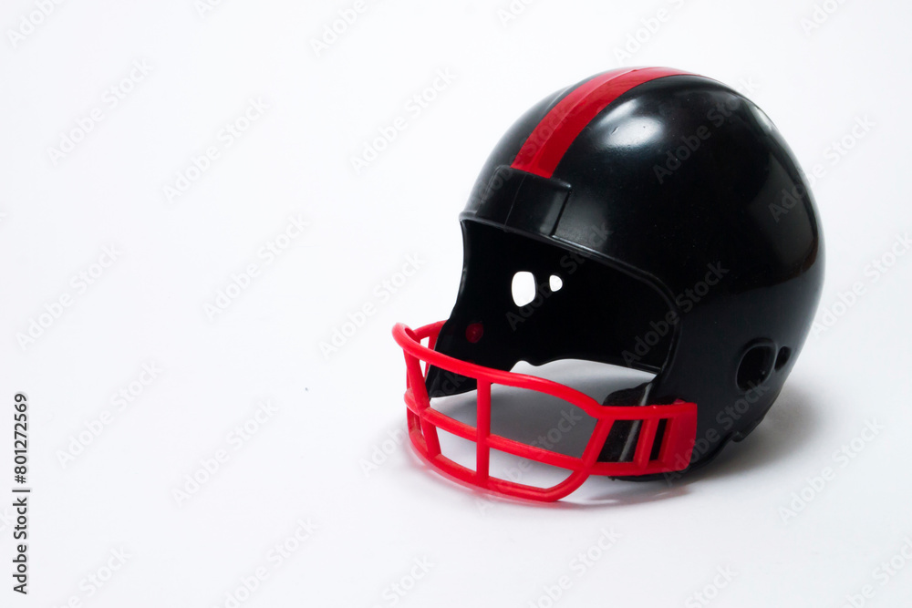 Red and black miniature american football helmets with white background Red and black miniature american football helmets with white background