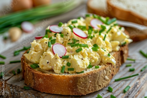 Bread with egg salad, garnished with radishes and chives