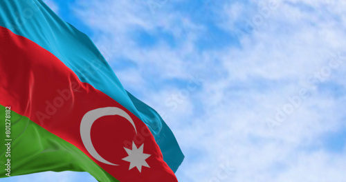 The national flag of Azerbaijan waving in the wind on a clear day.