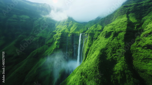 Nature Beauty  Breathtaking waterfall cascading down lush green mountainside