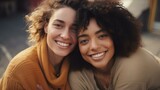 Two young multiracial women smiling at each other