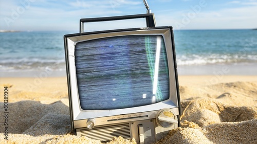 television with glitch next to the sea
