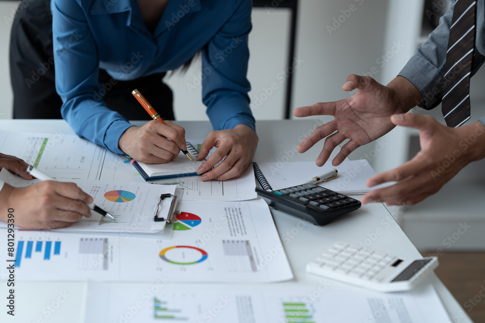 close-up hands image, Professional Asian male and female financial consultant or analyst working with them team, brainstorming and analyzing financial data on the report together in the office