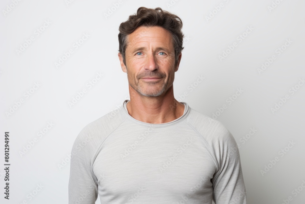 Portrait of a content man in his 40s showing off a thermal merino wool top isolated in white background Portrait of a content man in his 40s showing off a thermal merino wool top isolated in white background
