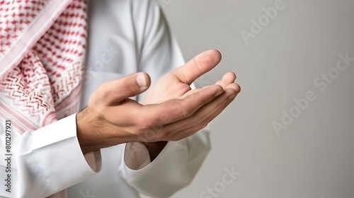 Arabic man wearing a Saudi bisht and traditional white shirt, hand gesture: opening 2 palms.