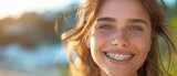 An image of a woman grinning up close with braces on her teeth