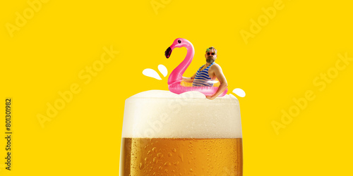 Man in striped swimsuit floating on swimming circle at top of foamy lager beer against bright yellow background. Contemporary art collage. Concept of alcohol drink, surrealism, celebration, creativity