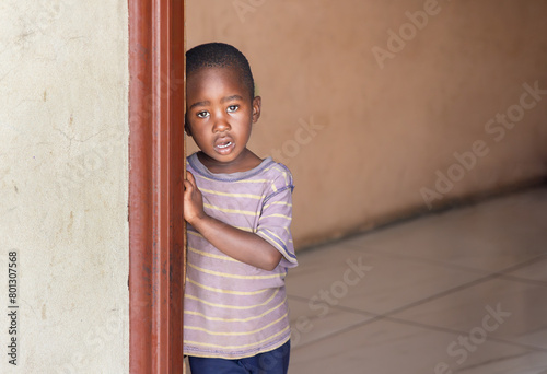 Картината върху платно african village , lonely single orphan child in an empty house, standing waiting