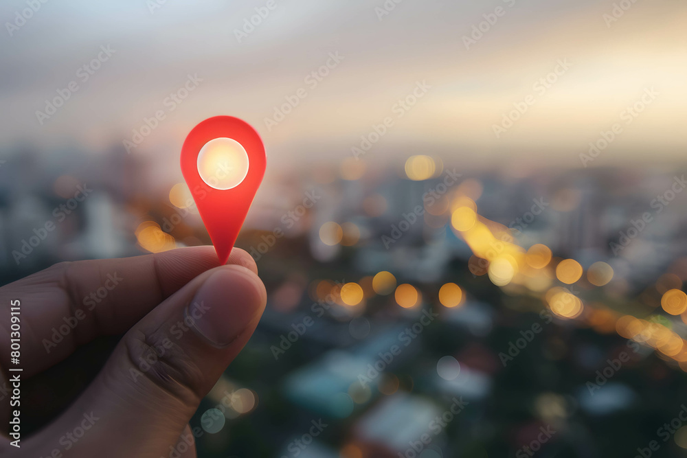 Investing in real estate and land to create returns concept, demand for purchasing land in a good location, close-up of a person hand holding red pin icon in city background Investing in real estate and land to create returns concept, demand for purchasing land in a good location, close-up of a person hand holding red pin icon in city background