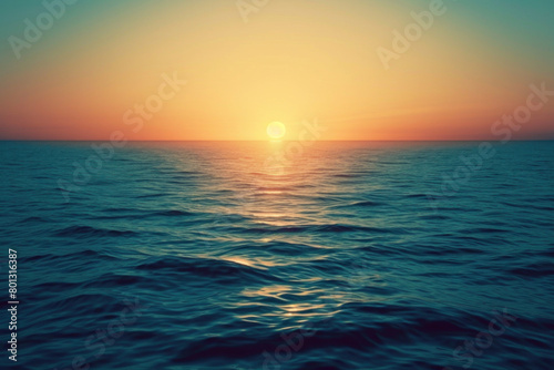 Calming sunset over the ocean horizon, with the sun casting a golden glow across the tranquil sea waters. © KirKam