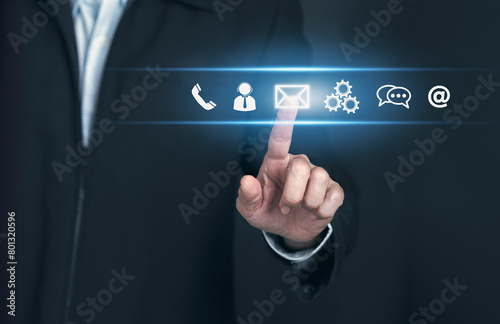 Contact us or Customer support hotline people connect. Businessman  touching on virtual screen contact icons ( email, address,smartphone, live chat, internet wifi ).Contact us connection concept.