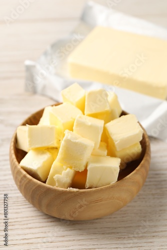 Tasty butter on light wooden table, closeup