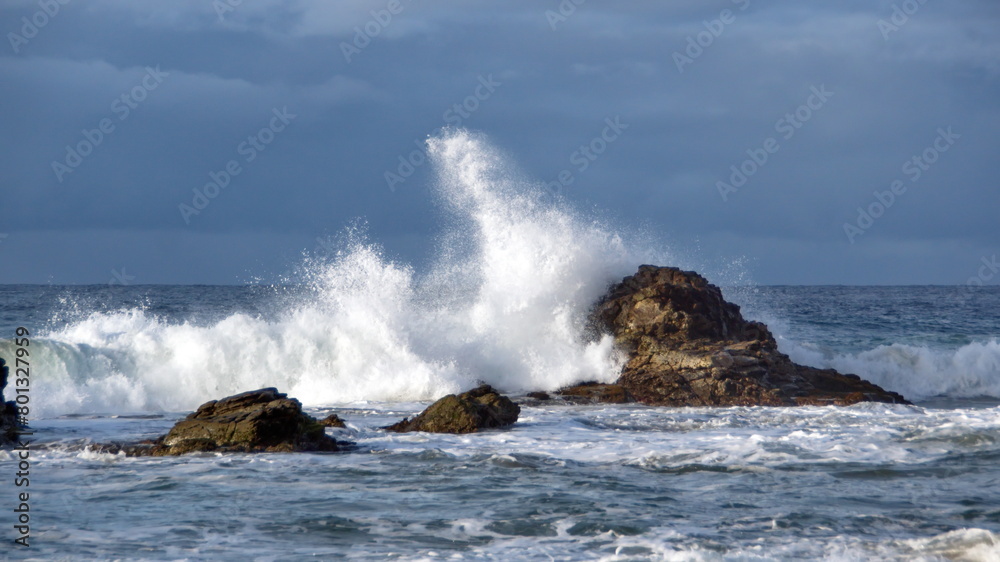 Waves breaking over rocks just off the beach in Zipolite, Mexico Waves breaking over rocks just off the beach in Zipolite, Mexico