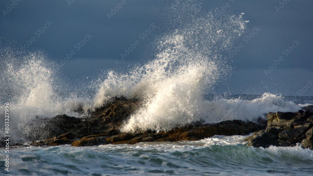 Waves breaking over rocks just off the beach in Zipolite, Mexico Waves breaking over rocks just off the beach in Zipolite, Mexico