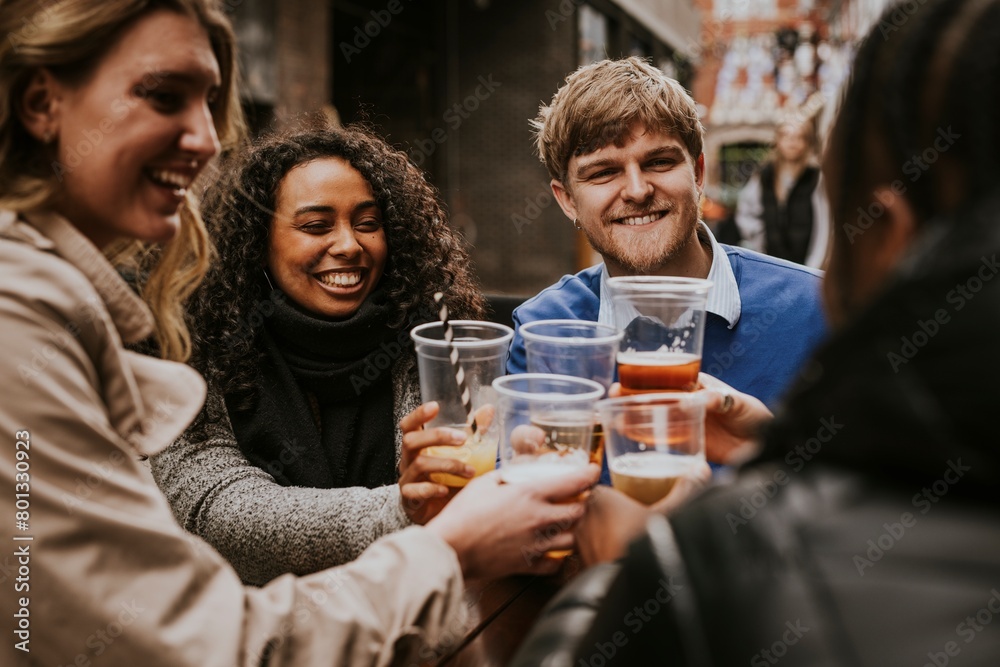 Diverse friends drinking beer in plastic cups Diverse friends drinking beer in plastic cups