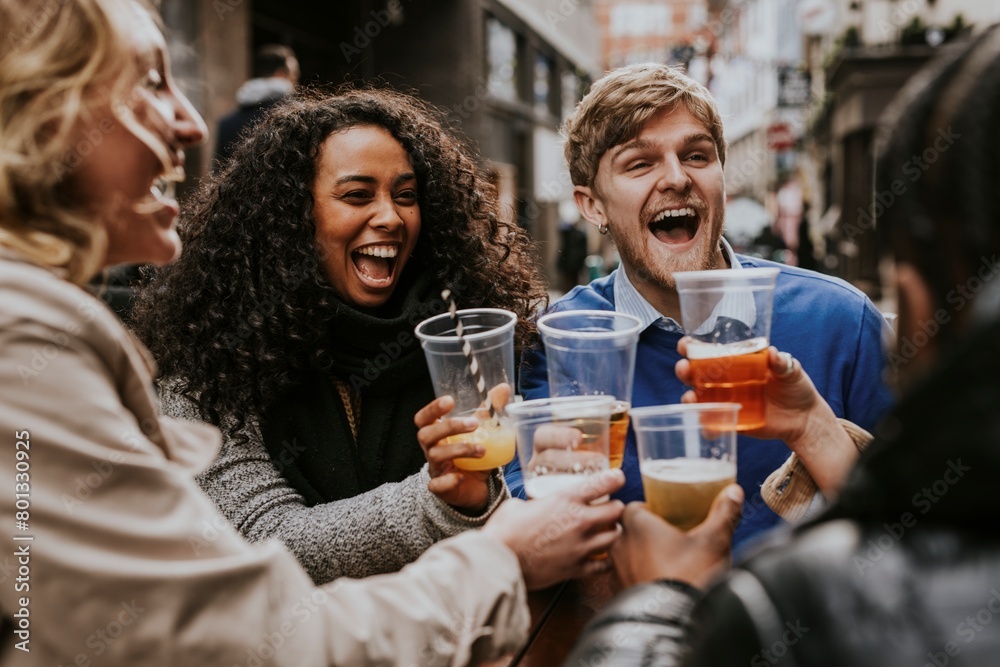 Diverse friends drinking beer in plastic cups Diverse friends drinking beer in plastic cups