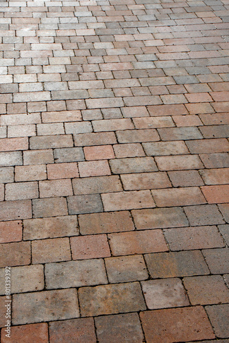 Paving made up of lots of red block paving stones leading into the distance