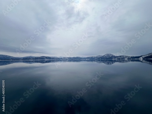 Beautiful view of Lake Tazawa with snowy mountains in the distance. Semboku, Akita, Japan photo