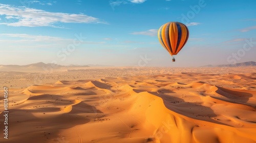 Hot air balloon floating over desert in sahara with copy space area.