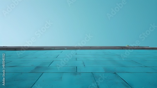 Minimalist Blue Building With Reflective Pool and Clear Sky