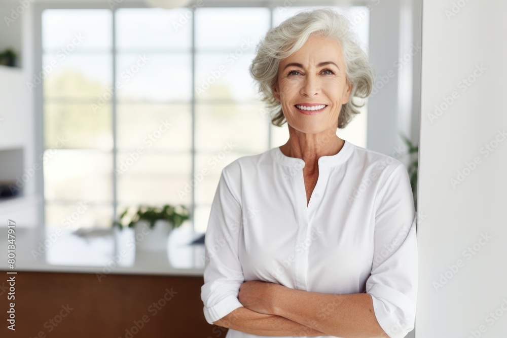 Portrait of a happy woman in her 60s donning a classy polo shirt on modern minimalist interior Portrait of a happy woman in her 60s donning a classy polo shirt on modern minimalist interior