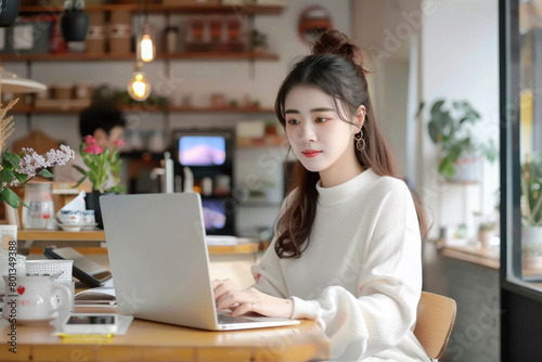 Modern lifestyle of a woman entrepreneur, working on her laptop at a vibrant cafe. Embrace the freedom of remote work and the bustling energy of urban life.