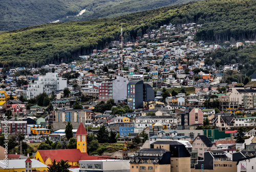 Ushuaia, Argentina - December 28, 2022: The city skylines on the mountain slopes of Ushuaia, Argentina with the port visible in the background
