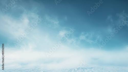 A serene winter scene showcasing a gentle, hazy cloudscape, emphasizing the calm and peaceful nature of a frosty day.