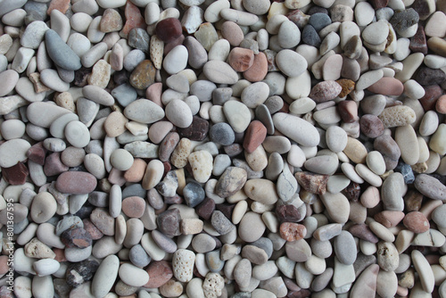 Background texture of pebbles or small river stone, flat lay or top view