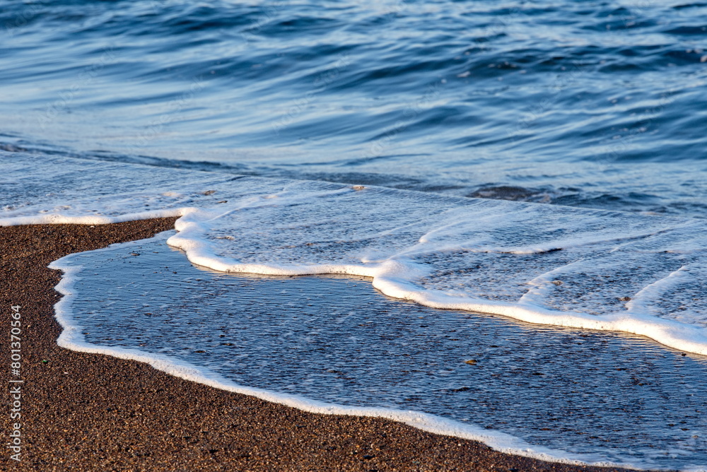 Obraz premium Russia. The Far East. The Kuril Islands. The remains of destroyed waves on volcanic sand on the shore of the Sea of Okhotsk island of Iturup.