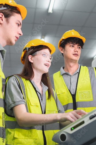 Professional engineering or technician team are discussing or having a conversation while working on PLC Control panel CNC machine to control the efficiency of robotic machinery to maintenance program