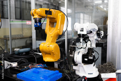 Automated Manufacturing Facility  Industrial robot works automatically in smart autonomous factory. Robot Arm at Production Line at Modern Bright Factory. Concept of electronic  technology  innovation