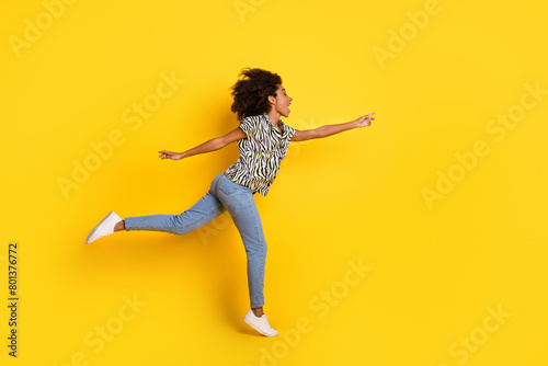 Portrait photo of glamour young charming american woman trying grab small thing empty spae isolated on yellow color background photo