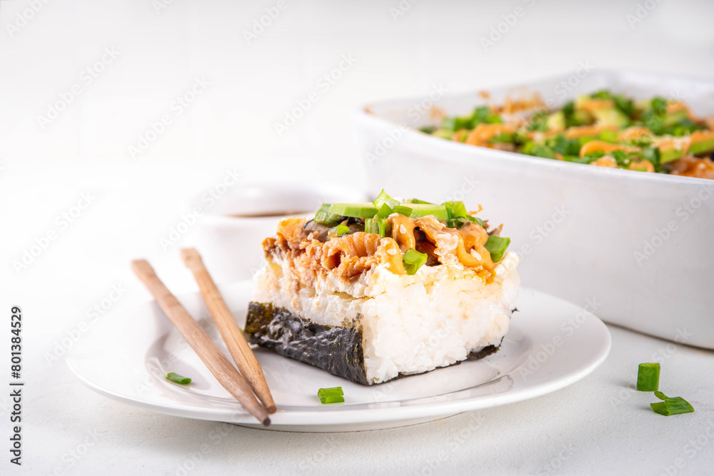 Philadelphia Sushi Bake Recipe Casserole made with Rice, cream cheese, salmon trout, seaweed, avocado, sauce, green onion. Served with toasted nori sheets likea taco