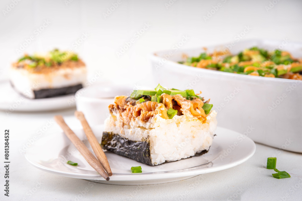 Philadelphia Sushi Bake Recipe Casserole made with Rice, cream cheese, salmon trout, seaweed, avocado, sauce, green onion. Served with toasted nori sheets likea taco