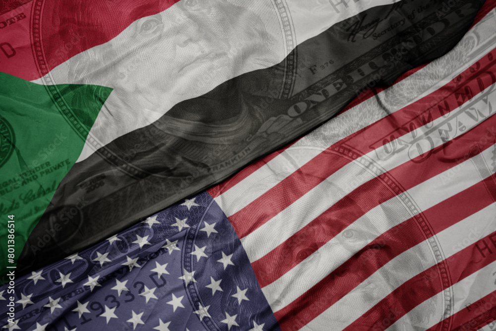Obraz premium waving colorful flag of united states of america and national flag of sudan on the dollar money background. finance concept.