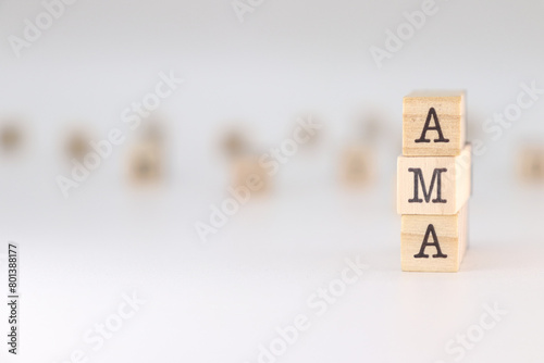 AMA word. Concept of ask me anything written on wooden cubes isolated on white background. photo