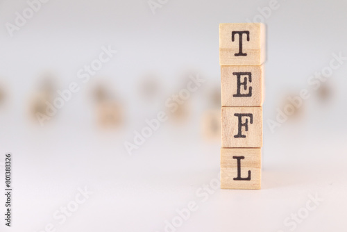 Acronym TEFL. Concept of Teaching English as a foreign language written on wooden cubes isolated on white background photo