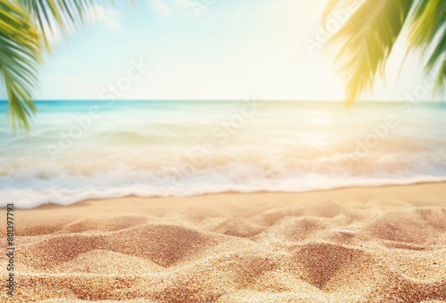 Beautiful defocused natural background for summer holidays and travel. Golden sand of a tropical beach, blurred palm leaves on a sunny day. © Laura Pashkevich