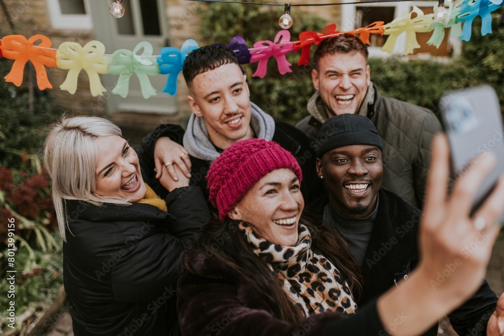 Fototapeta premium Diverse friends taking a group selfie at a Christmas party