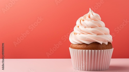 Stylish and minimal image of a gourmet cupcake on a pastel coral background, centered with a balanced composition for a sweet, inviting look