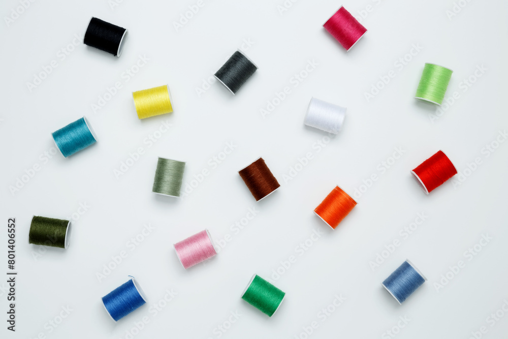 Multicolored sewing threads on white background Multicolored sewing threads on white background
