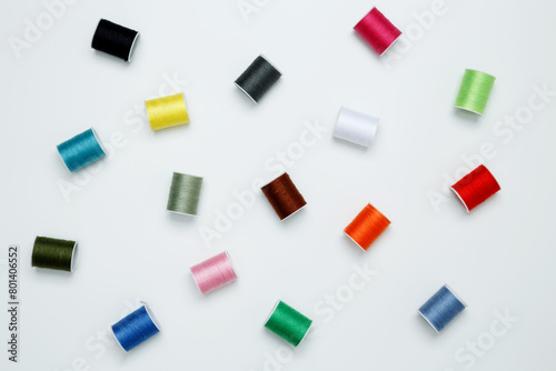 Multicolored sewing threads on white background