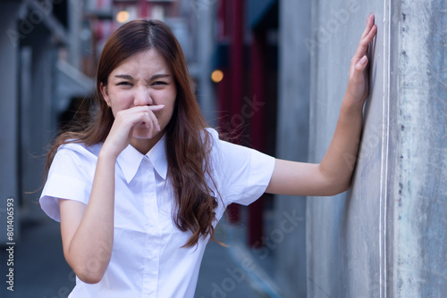 Stinking Odor and Disgusted Expression, Woman Reacting to Unpleasant Smell, Concept Image photo