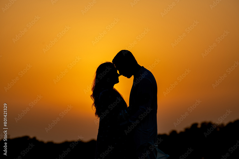 Silhouette Of Pakistani  Couple During Sunset At Sea view Karachi beach wedding shoot. No Face