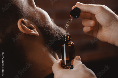 Spa cosmetic oil for growth hair of beard man and serum for skincare. Treatment wellness beauty procedure for mens in barbershop © Parilov